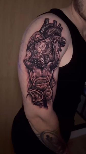 Realism atlas heart tattoo by @korneltattoo