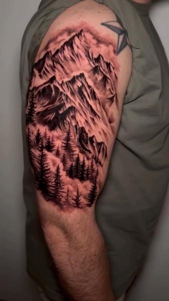 Blackwork mountain landscape tattoo by @korneltattoo