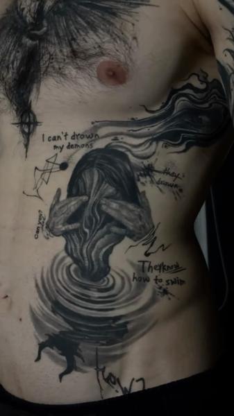 Realism drowning figure tattoo by @koval.ink