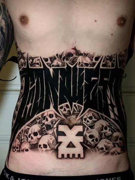 Blackwork skull pile lettering tattoo by @kriswilson_ink