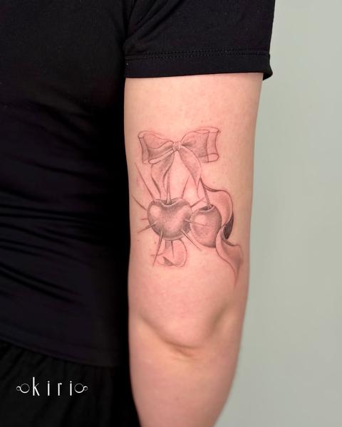 Fine line bow and cherries tattoo by @kiri.vrs