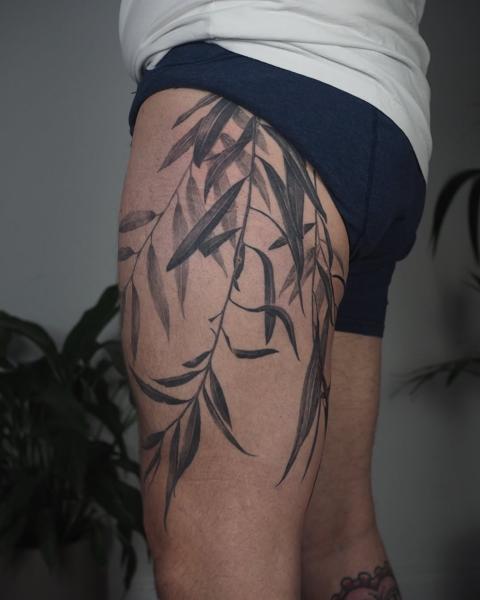 Blackwork bamboo leaves tattoo by @lionoflauratattoos