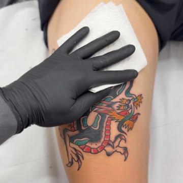 Traditional dragon tattoo by @leeregantattoo