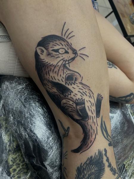 Illustrative blackwork playful otter tattoo by @ashestattoo