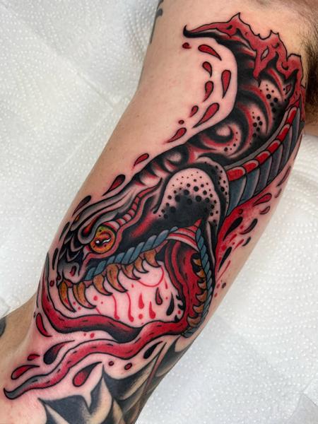 Traditional dragon head tattoo by @lewismckechnie
