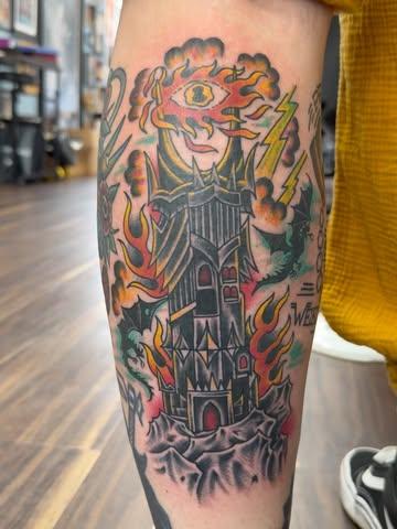 Traditional flaming tower tattoo by @shedwolf