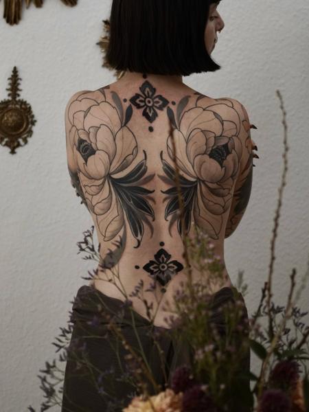 Blackwork floral backpiece tattoo by @lore.morato