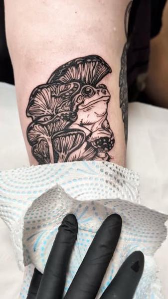 Blackwork frog mushrooms tattoo by @lorr.ink