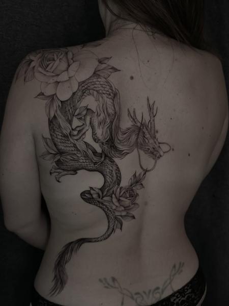 Fine line floral dragon tattoo by @loreta.win.tattoo