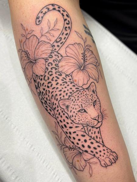 Blackwork leopard hibiscus tattoo by @lucie.tattoo