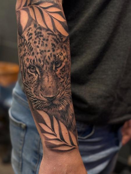 Realism leopard portrait tattoo by @lukaszmtattoo