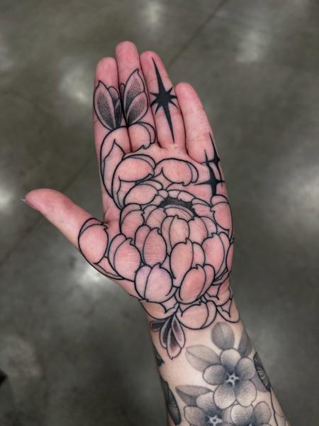 Blackwork floral design tattoo by @lukeaashley
