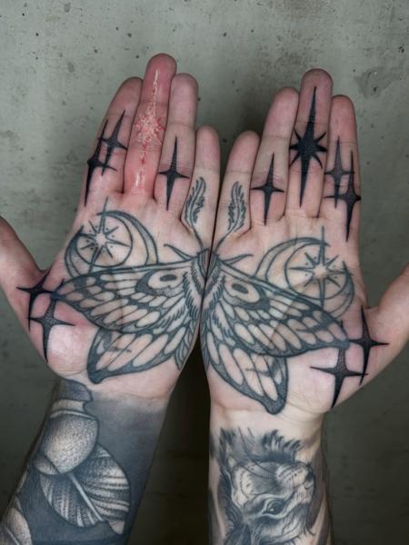 Blackwork moth and stars tattoo by @lukeaashley