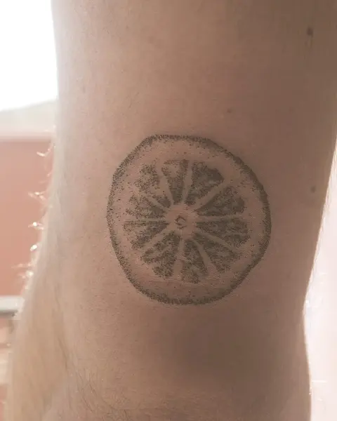 Dotwork citrus slice tattoo by @tatts_n_tonic