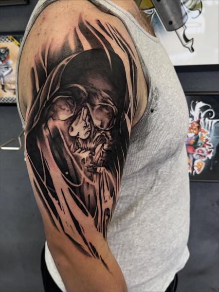 Black and grey realism hooded skull tattoo by @mads.flugt