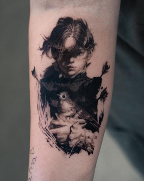 Realism portrait with bird tattoo by @magetower.tattoo