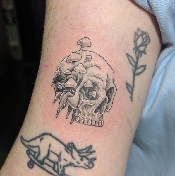 Blackwork mushroom skull tattoo by @maisie.llewellyn