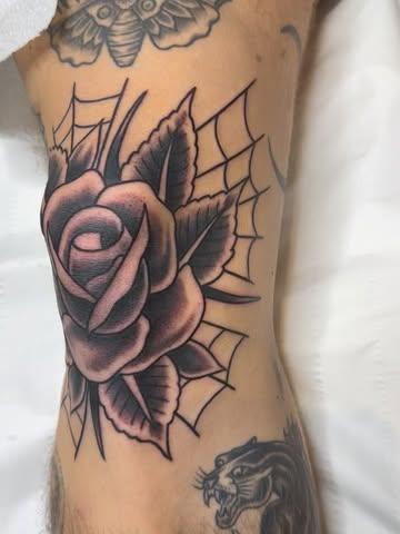 Traditional rose with web tattoo by @not_cultured_tattoo