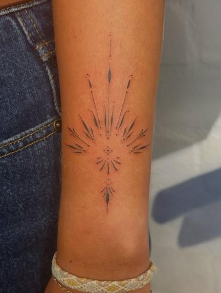 Fine line ornamental burst tattoo by @marcelclaude.tattoo