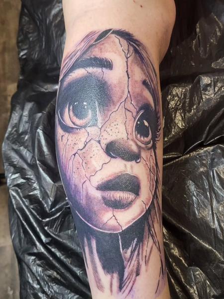 Realism cracked doll face tattoo by @blood_sweat_and_tears_tattoo