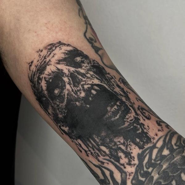 Blackwork zombie face tattoo by @mazira.tattoos