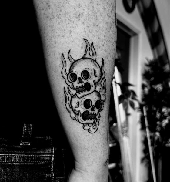 Blackwork flaming skulls tattoo by @mariamanzitattoo