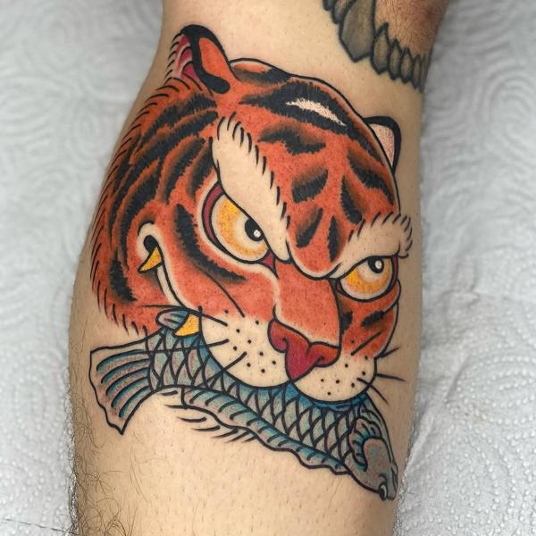 Traditional tiger with fish tattoo by @marsu_tattooer