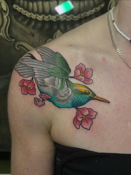 Traditional hummingbird with flowers tattoo by @mvrktattoo