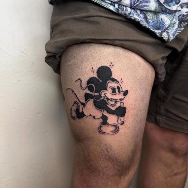 Blackwork cartoon character tattoo by @quipstertattoos