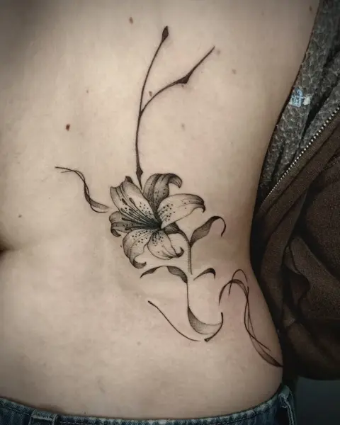 Fine line floral lily tattoo by @martatattoos