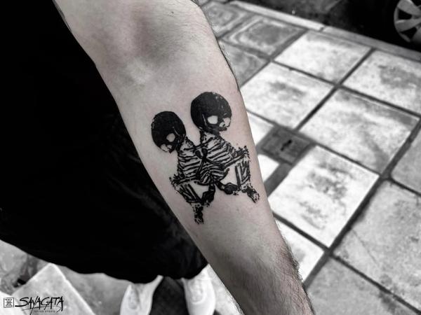 Blackwork conjoined skeletons tattoo by @matina_macabre_tatt