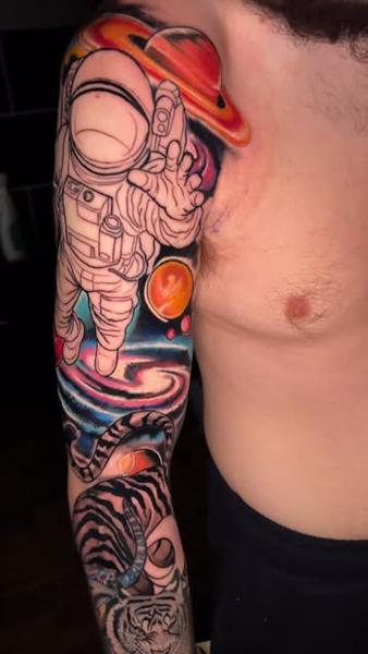 Realism astronaut and tiger tattoo by @mattedwardstattoos