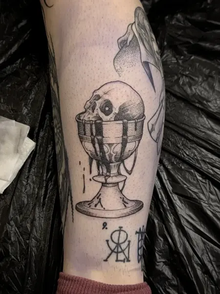 Blackwork skull goblet tattoo by @fearn_tattoo