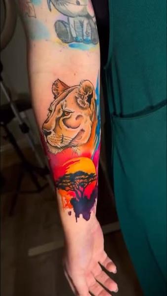 Illustrative realism lioness savannah sunset tattoo by @meg.tattz