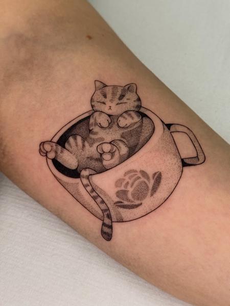 Fine line cat in teacup tattoo by @hunn1i