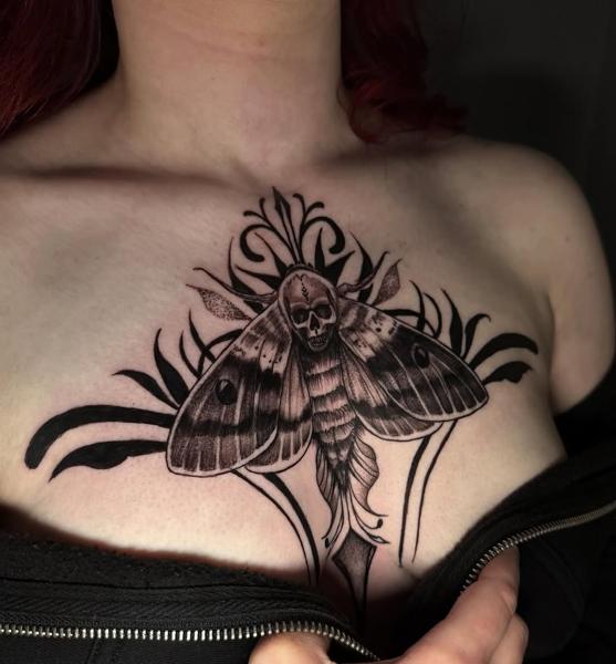 Blackwork skull moth tattoo by @melina.tatts