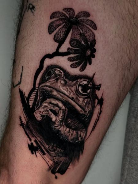 Blackwork frog with flowers tattoo by @melina.tatts