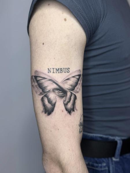 Blackwork butterfly with text tattoo by @mia.ink._