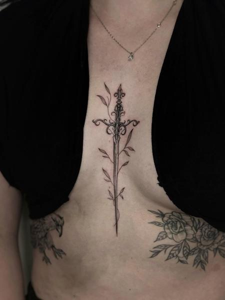 Fine line ornamental sword tattoo by @mia.ink._