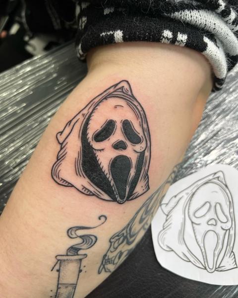 Blackwork screaming mask tattoo by @mikotattoo