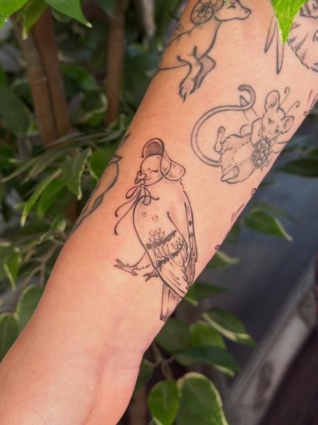Fine line bird in bonnet tattoo by @moz.tattoos