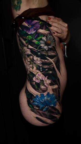Realism floral vine tattoo by @moriel.seror
