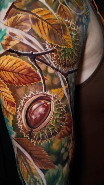 Realism chestnut leaves tattoo by @moriel.seror