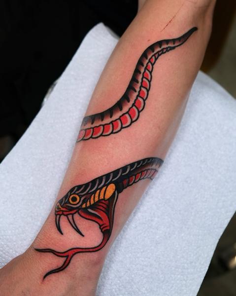 Traditional snake tattoo by @morstattoo
