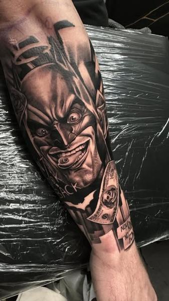 Realism jokerized batman tattoo by @mortenstubbe_tattoos