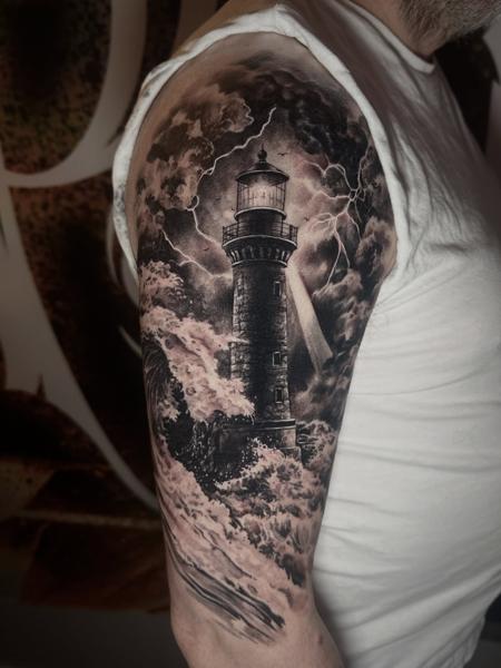 Realism stormy lighthouse tattoo by @mortenstubbe_tattoos