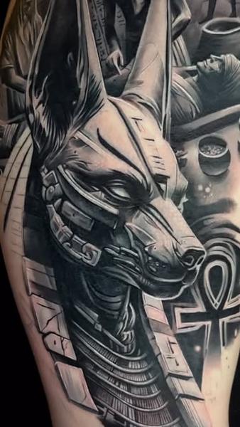 Black and grey realism cybernetic anubis tattoo by @mortenstubbe_tattoos
