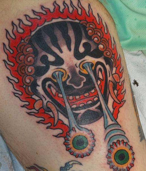Traditional flaming mask tattoo by @mr_wrath