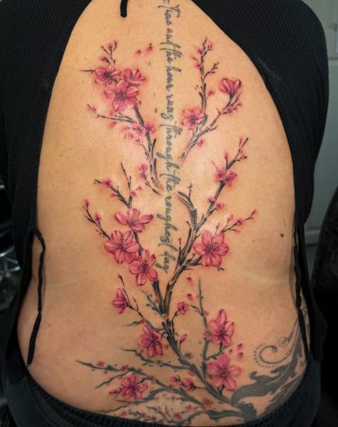 Realism cherry blossoms tattoo by @nstia.tatts