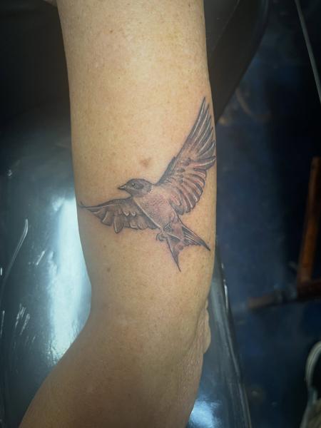 Realism flying bird tattoo by @necro_comicon